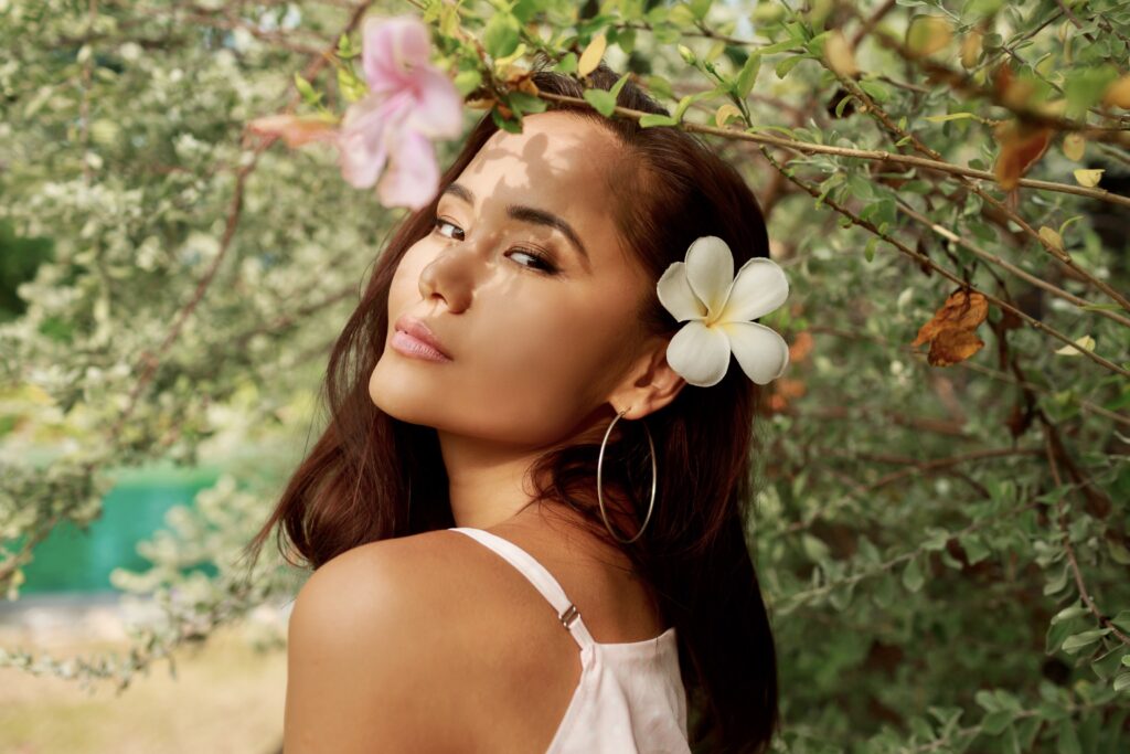 Exuding charm and grace, this Asian woman embraces her natural beauty in the midst of a blossoming garden. The flowers woven into her hair reflect her vibrant spirit and celebrate the season's joy. #BlossomingBeauty #AsianVibes #FlowerAdornment