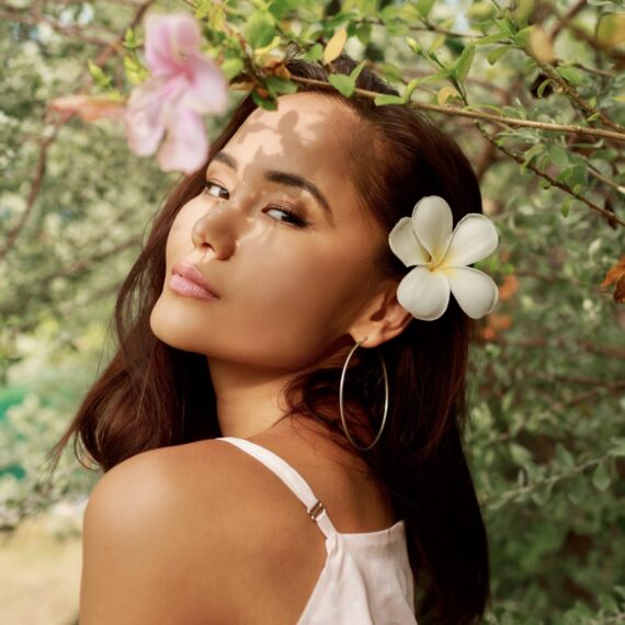 Exuding charm and grace, this Asian woman embraces her natural beauty in the midst of a blossoming garden. The flowers woven into her hair reflect her vibrant spirit and celebrate the season's joy. #BlossomingBeauty #AsianVibes #FlowerAdornment