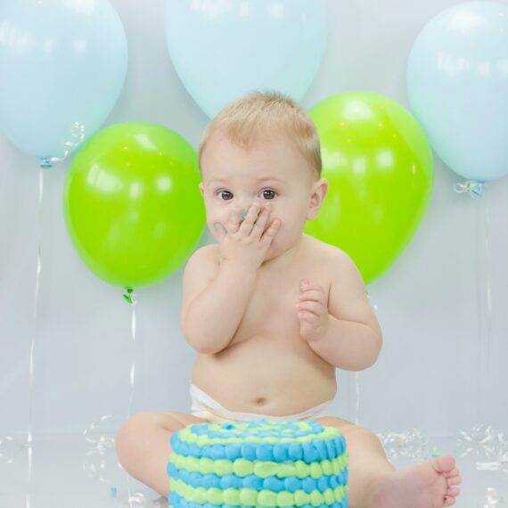 Joyful cake-covered toddler