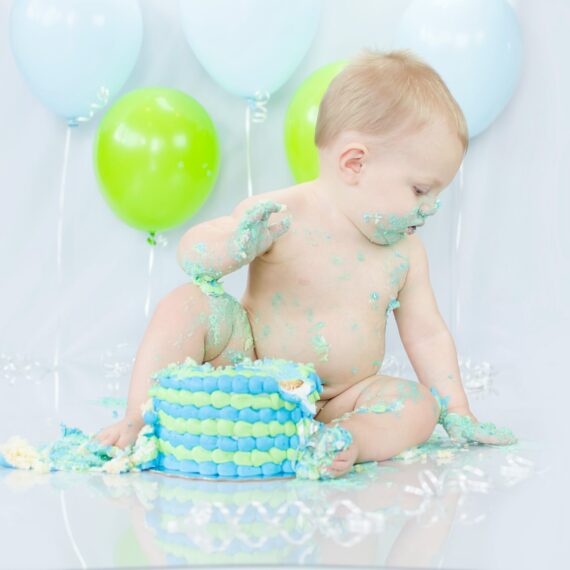 Joyful cake-covered toddler