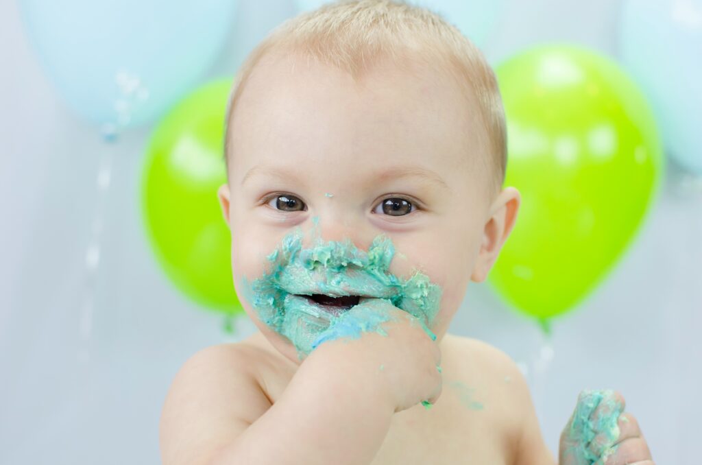 Joyful cake-covered toddler